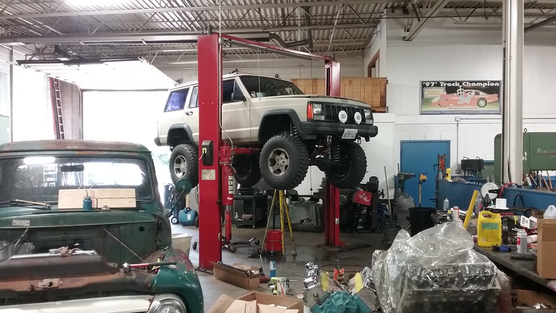 Jeep with puddles of various fluids, degreasers, and mineral spirits. And all the hydraulic oil leaking out of our damn lift. I think it started leaking in like 1995, but apparently we’re still waiting for it to fix itself... because that’s what leaking lifts do...